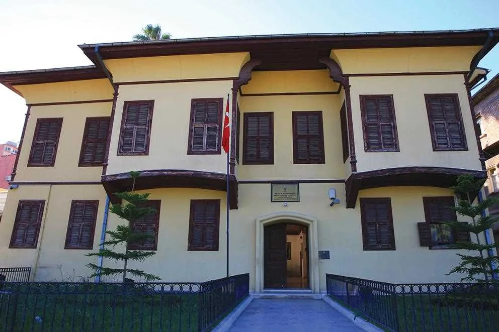 Atatürk Evi Müzesi ön cephesi, sıcak atmosfer ve yeşil bitkilerle çevrili.