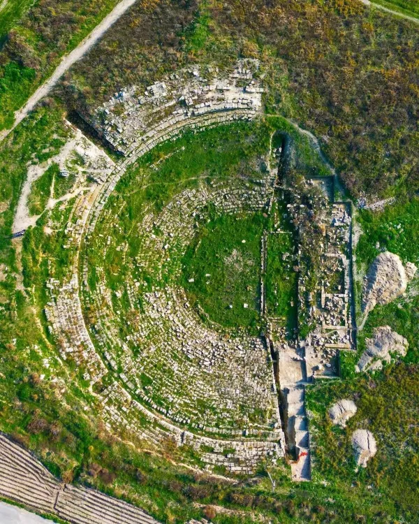 Yeşillik alan üzerindeki Magarsus Antik Kenti'nin amfi tiyatrosu kalıntıları.