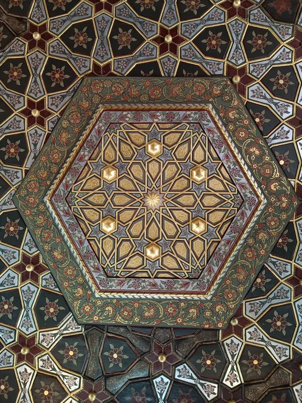 Zengin detaylara sahip Osmanlı tarzı tavan süslemesi, altın altıgen ve renkli çiçek desenleriyle