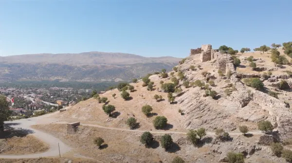 Tarihi kalıntılar, doğal peyzaj ve dağ manzarası içeren bir görüntü
