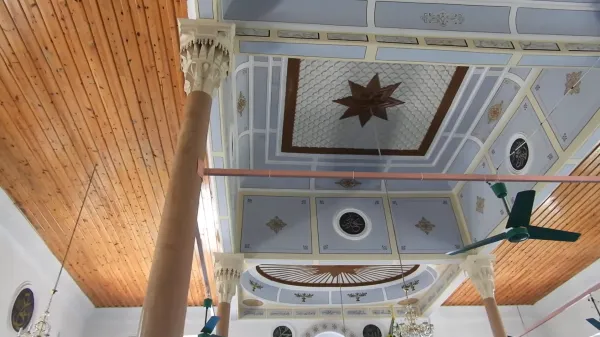 Açık mavi ve beyaz tonlarında süslü tavan, merkezde yıldız figürü ve altın detaylarla bezeli.