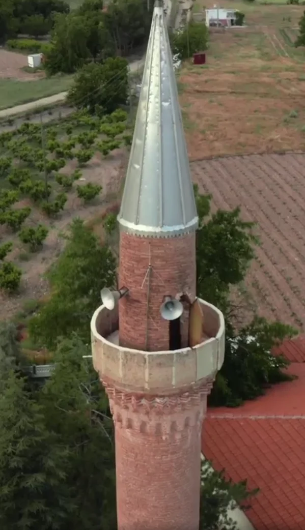 Küçükgökçeli Kırık Minare Camii'nin tuğla minaresi ve çevresindeki doğal manzara.