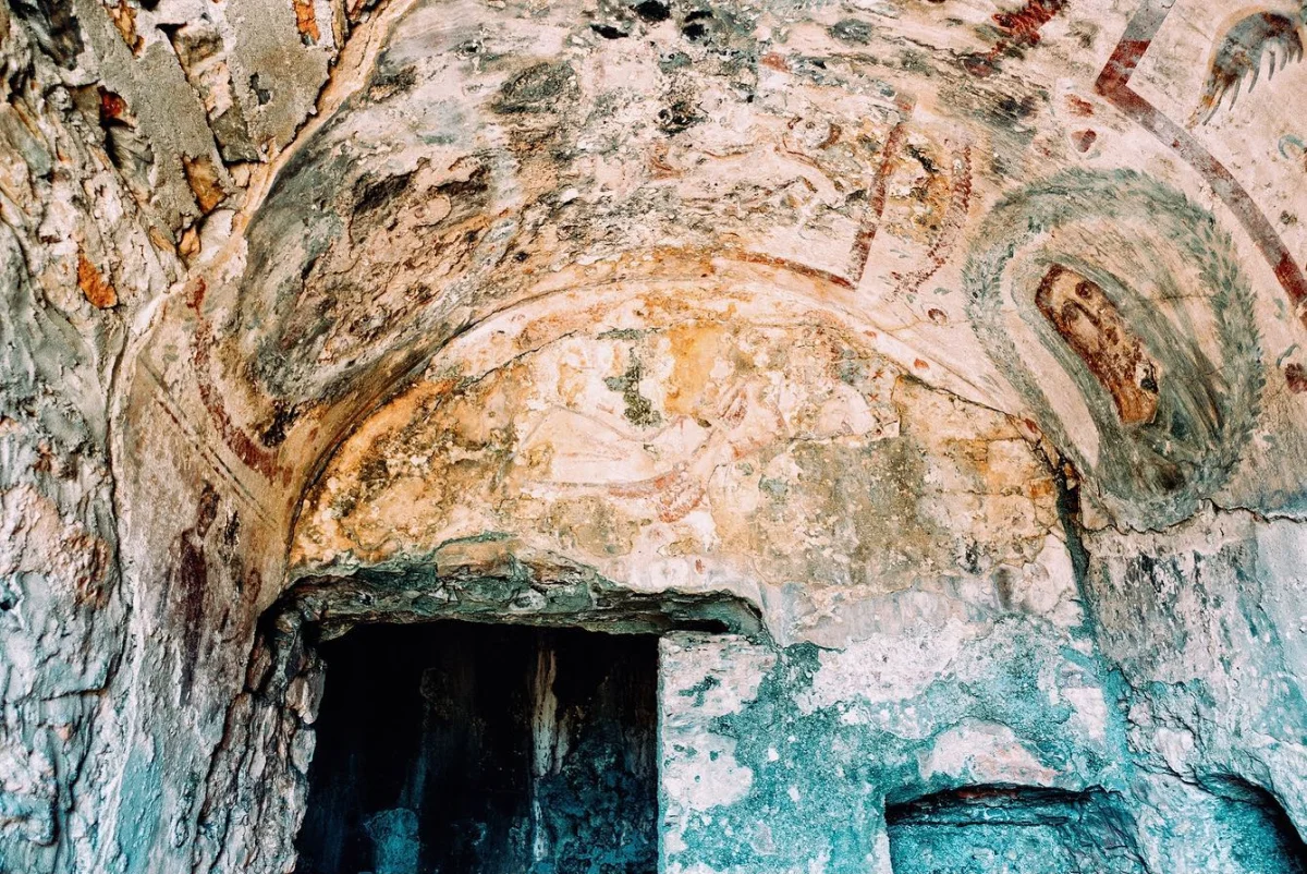 Eski yapının iç yüzeyinde fresklerle süslenmiş duvarlar ve tavan